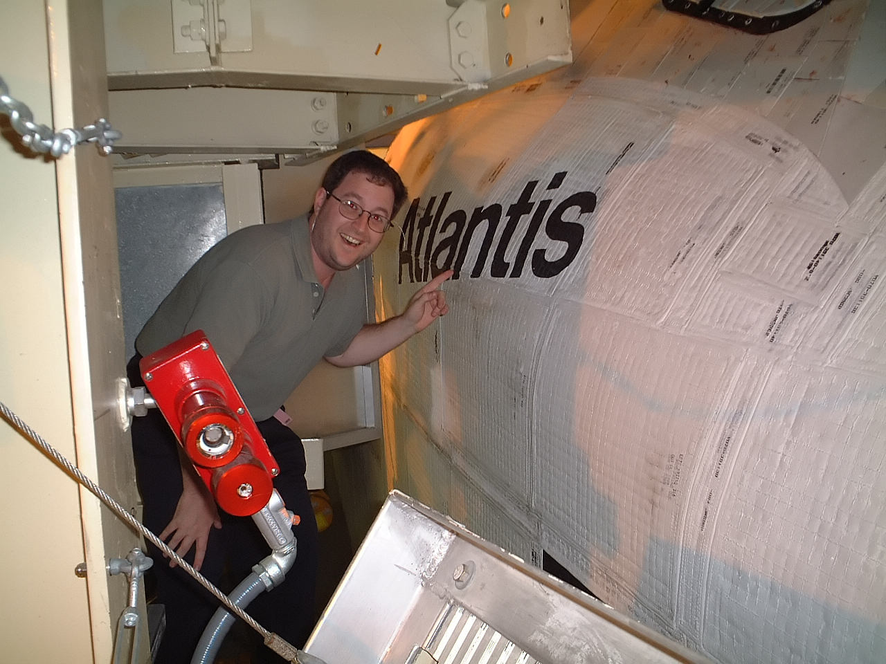 Steven Schain beside the space shuttle Atlantis in NASA’s Orbiter Processing Facility in 2001